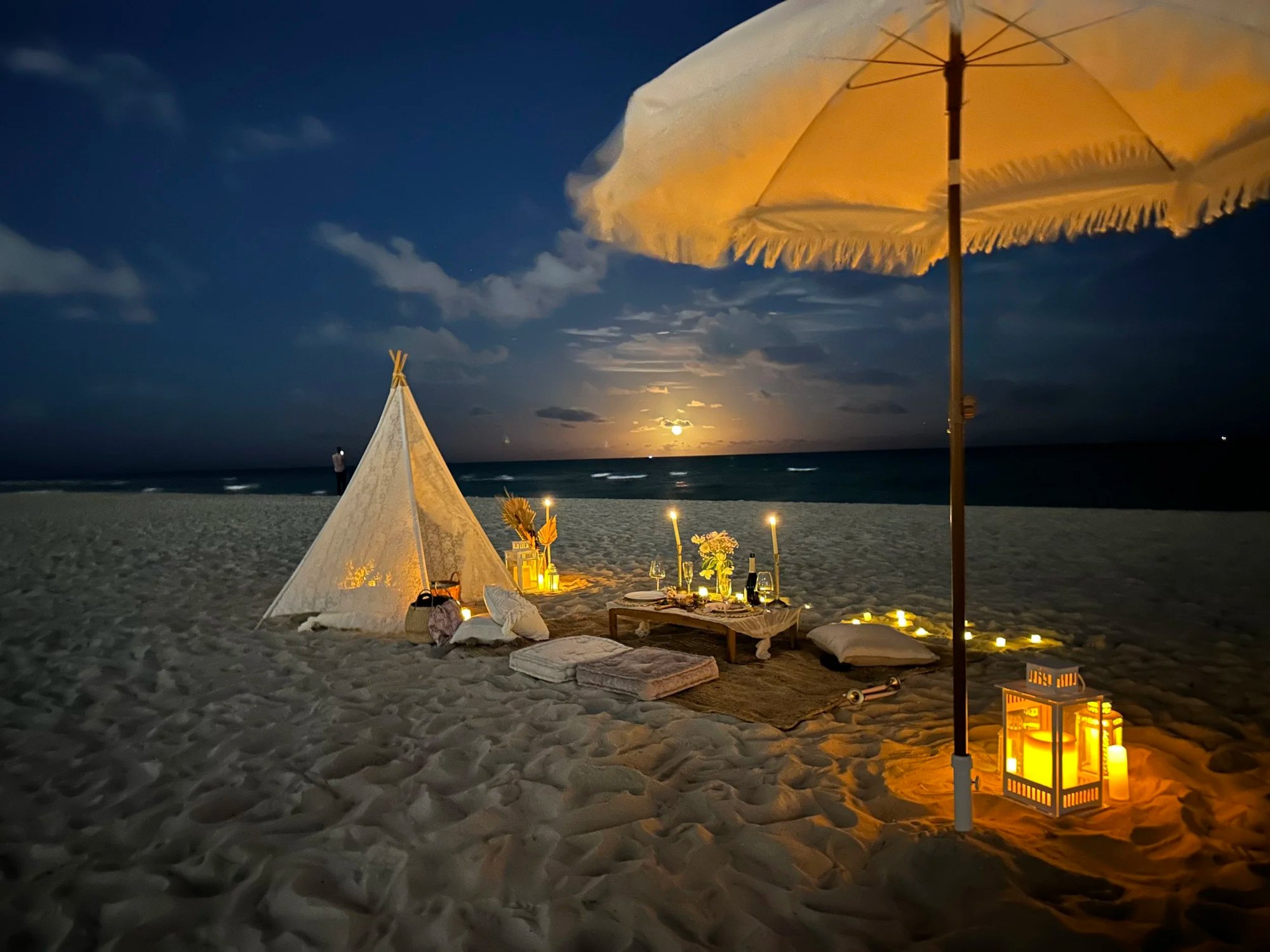 Night romantic beach picnic Miami candles lanterns